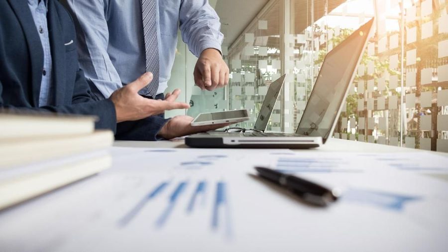 Business adviser analyzing financial figures denoting the progress in the work of the company.