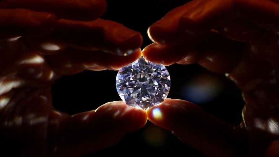 An assistant holds a 102.34 carat white diamond at Sotheby's auction house in London, Britain February 8, 2018. REUTERS/Hannah McKay TPX IMAGES OF THE DAY