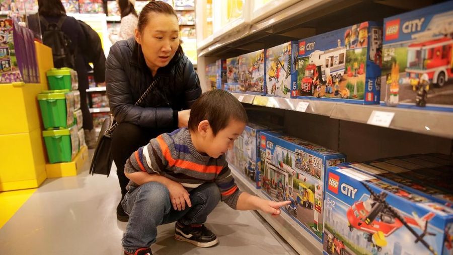 FILE PHOTO: A customer carries a Lego box at a Lego store in Beijing, China January 13, 2018. REUTERS/Jason Lee/File Photo