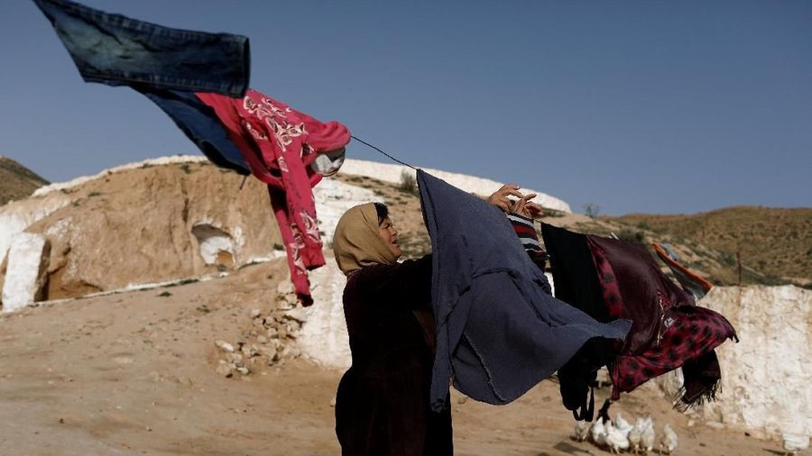 Saliha Mohamedi, 36, hangs washing at her troglodyte house on the outskirts of Matmata, Tunisia, February 5, 2018. 