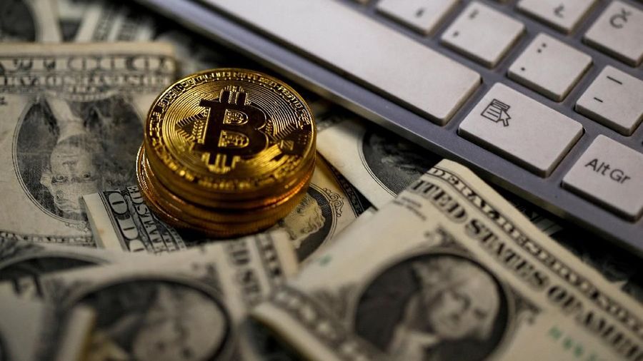 FILE PHOTO: Bitcoin (virtual currency) coins placed on Dollar banknotes, next to computer keyboard, are seen in this illustration picture, November 6, 2017.  REUTERS/Dado Ruvic/Illustration/File Photo
