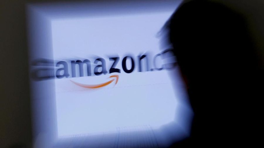 FILE PHOTO: A zoomed illustration image of a man looking at a computer monitor showing the logo of Amazon is seen in Vienna, Austria, on November 26, 2012. REUTERS/Leonhard Foeger/File Photo