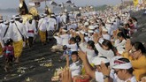 Iring-iringan masyarakat yang mengarak benda-benda sakral untuk disucikan dalam ritual Melasti menjadi pemandangan menarik bagi wisatawan yang datang ke Bali. (REUTERS/Johannes P. Christo)