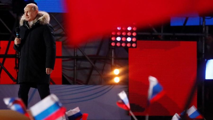 Russian President and Presidential candidate Vladimir Putin delivers a speech during a rally and concert marking the fourth anniversary of Russia's annexation of the Crimea region, at Manezhnaya Square in central Moscow, Russia March 18, 2018. REUTERS/Maxim Shemetov     TPX IMAGES OF THE DAY