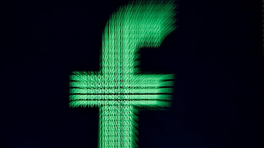 A 3D-printed Facebook logo is displayed in front of binary digits in this illustration taken, March 18, 2018. REUTERS/Dado Ruvic/Illustration