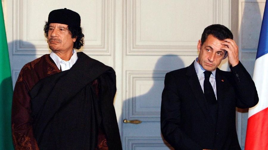 FILE PHOTO: France's President Nicolas Sarkozy (R) and Libyan leader Muammar Gaddafi attend a ceremony for the signature of 10 billion euros of trade contracts between the two countries at the Elysee Palace in Paris, December 10, 2007. Libya and France signed contracts for the purchase of 21 Airbus aircraft during the start of the five day visit of the Libyan leader. REUTERS/Patrick Hertzog/Pool/File Photo