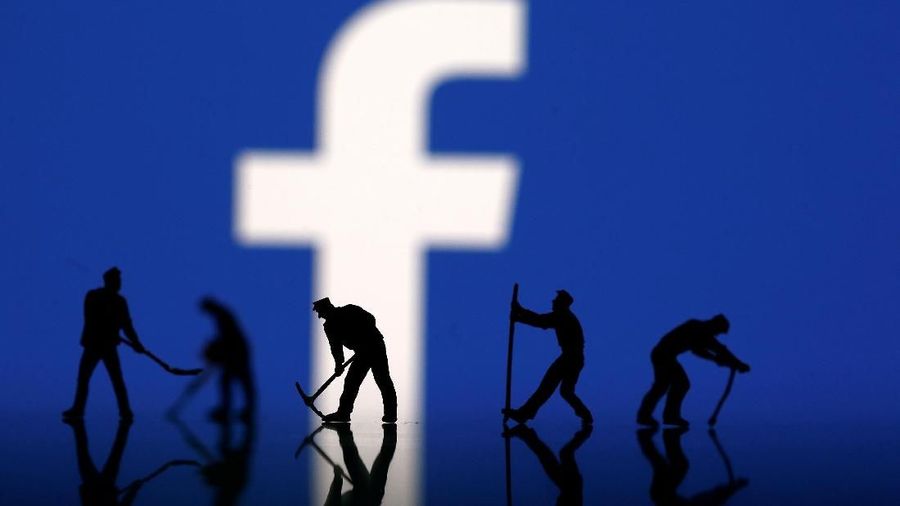 Figurines are seen in front of the Facebook logo in this illustration taken March 20, 2018. REUTERS/Dado Ruvic