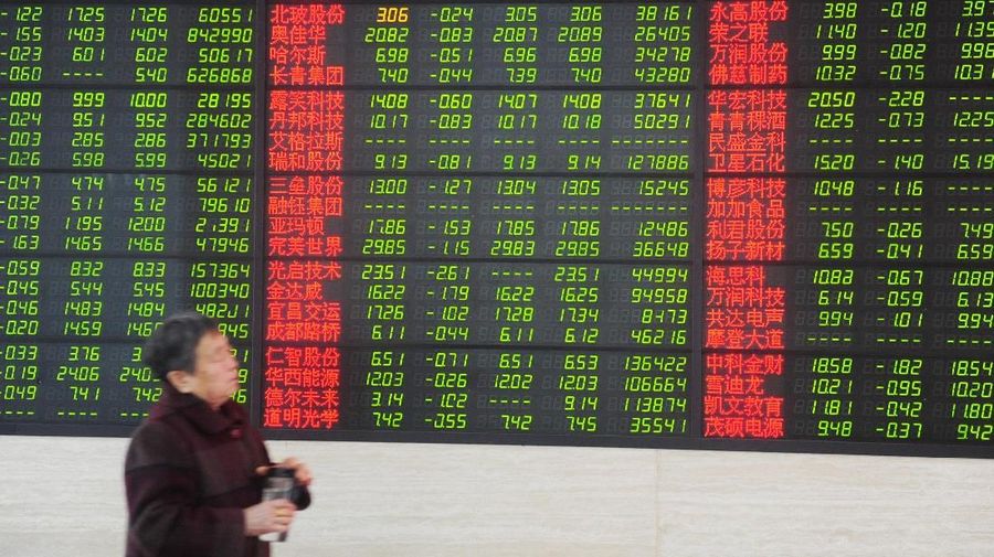 A man looks at a monitor showing stock information at a brokerage house in Jiujiang, Jiangxi province, China March 23, 2018. China Daily via REUTERS   ATTENTION EDITORS - THIS IMAGE WAS PROVIDED BY A THIRD PARTY. CHINA OUT.