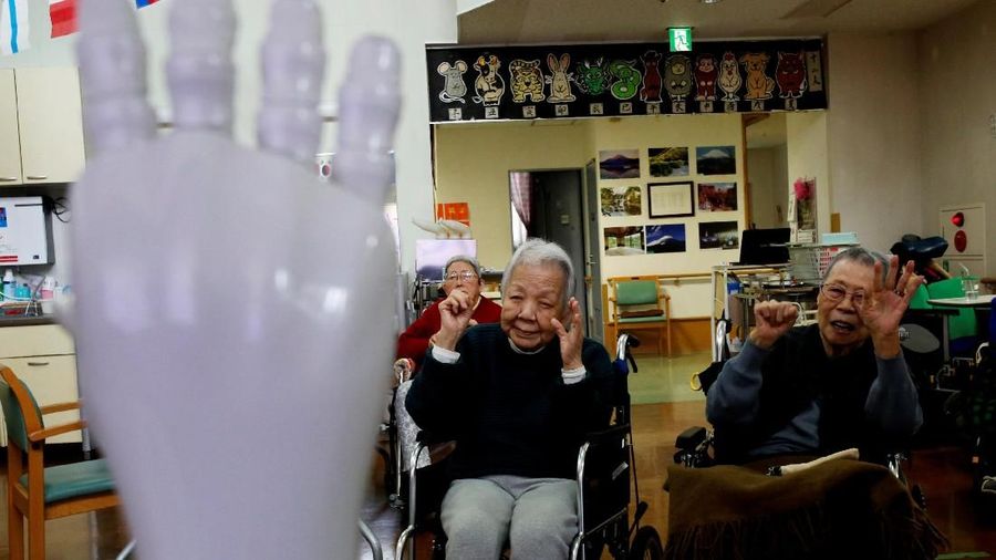 Residents follow moves made by humanoid robot 'Pepper' during an afternoon exercise routine at Shin-tomi nursing home in Tokyo, Japan, February 2, 2018. REUTERS/Kim Kyung-Hoon