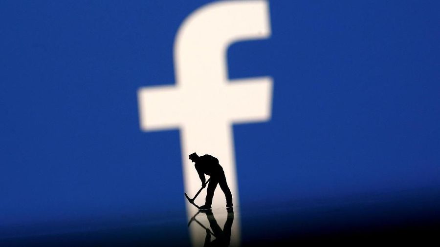 FILE PHOTO: A figurine is seen in front of the Facebook logo in this illustration taken, March 20, 2018. REUTERS/Dado Ruvic/Illustration/File Photo