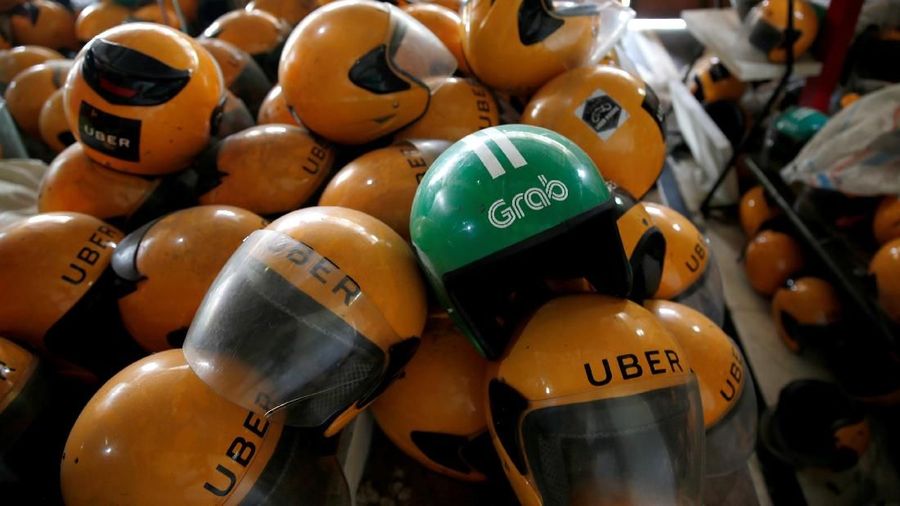 Used Grab and Uber helmets are seen at used-helmet shop in Jakarta, Indonesia, April 2, 2018. REUTERS/Beawiharta