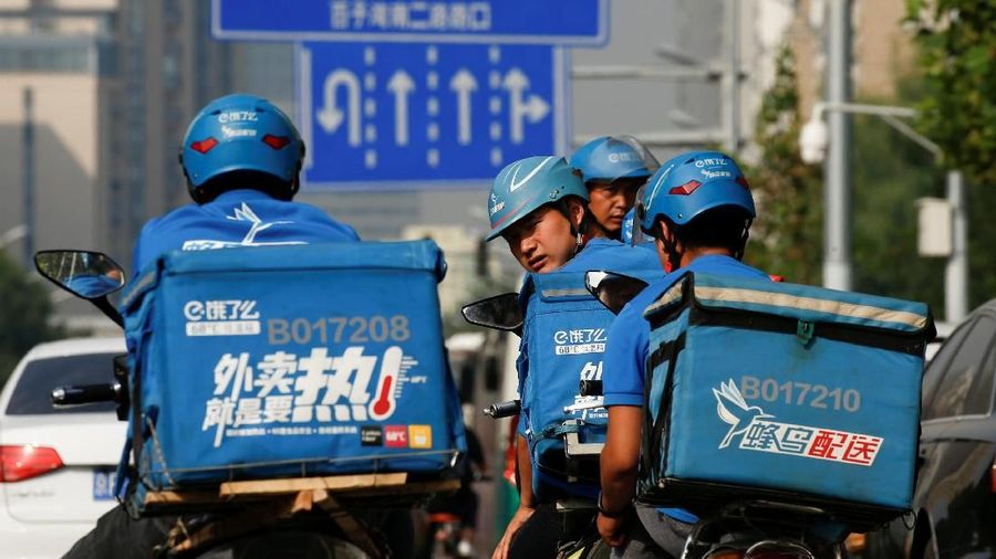 FILE PHOTO: Drivers of the food delivery service Ele.me after an internal security check before their morning shift in Beijing, China, September 21, 2017. REUTERS/Thomas Peter/File Photo