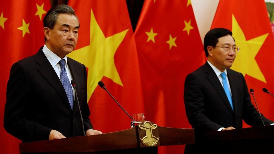 China's State Councilor and Foreign Minister Wang Yi (L) and Vietnam's Deputy Prime Minister and Foreign Minister Pham Binh Minh attend a news conference after their meeting at the Government Guesthouse in Hanoi, Vietnam April 1, 2018. REUTERS/Kham