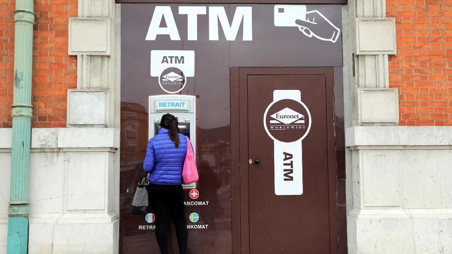 A woman withdraws money from an ATM machine in Nice, France, April 3, 2018. REUTERS/Eric Gaillard