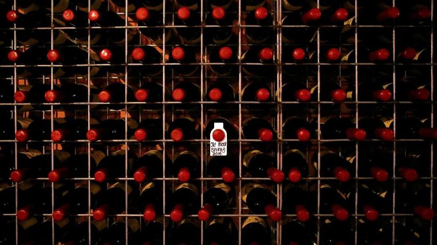 FILE PHOTO: Bottles of wine sit in a storage rack at Petersons Winery in the Hunter Valley, located north of Sydney in Australia, February 14, 2018. REUTERS/David Gray/File Photo