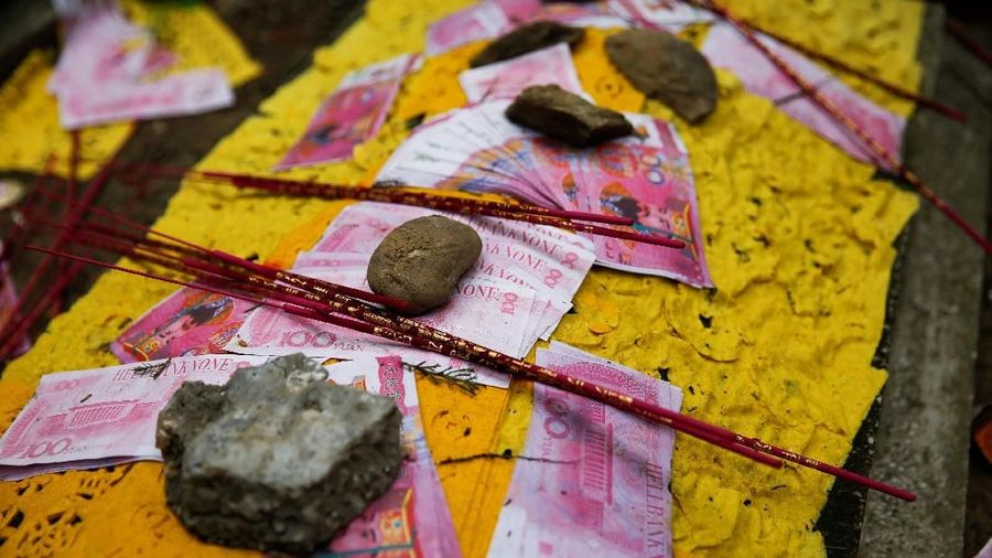 Fake money is scattered at a grave at Babaoshan Cemetery ahead of Qingming Festival, or Tomb Sweeping Day, in Beijing, China, April 4, 2018. REUTERS/Thomas Peter