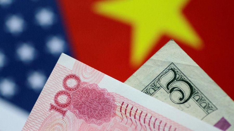 FILE PHOTO: U.S. Dollar and China Yuan notes are seen in this picture illustration June 2, 2017. REUTERS/Thomas White/Illustration/File Photo