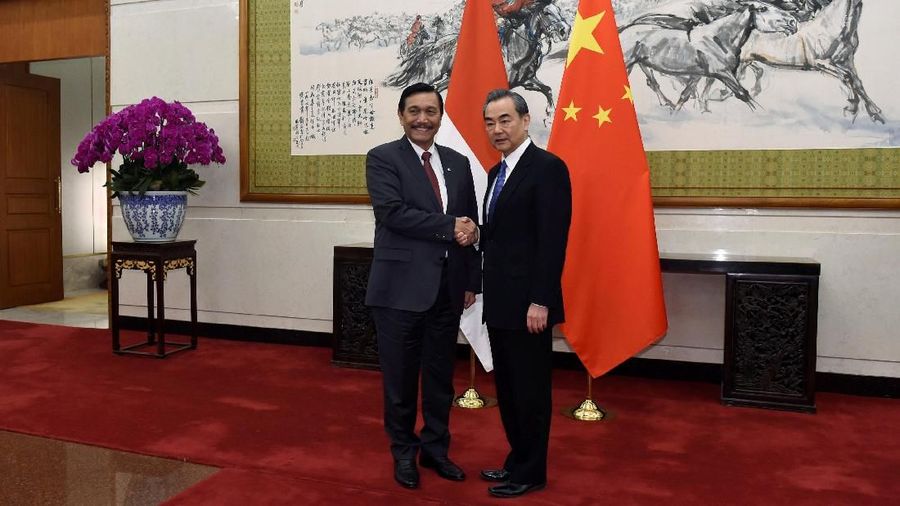 Indonesia's Coordinating Minister for Maritime Affairs Luhut Binsar Pandjaitan, left, shakes hands with Chinese Foreign Minister and State Councillor Wang Yi as they pose for the media before their meeting on April 12, 2018 at the Diaoyutai State Guesthouse in Beijing, China.   Parker Song/Pool via REUTERS
