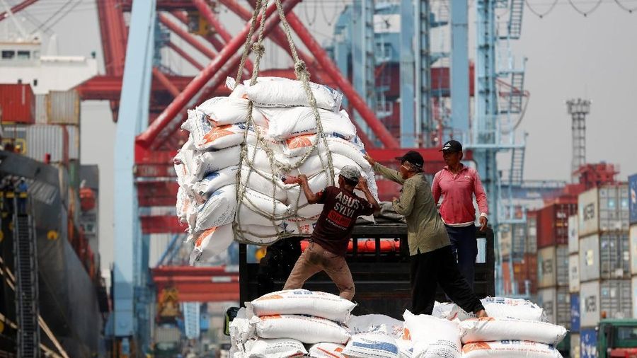 Workers help unload bags of rice from a cargo ship on to a truck at Tanjung Priok Port in Jakarta, Indonesia April 16, 2018.   REUTERS/Darren Whiteside