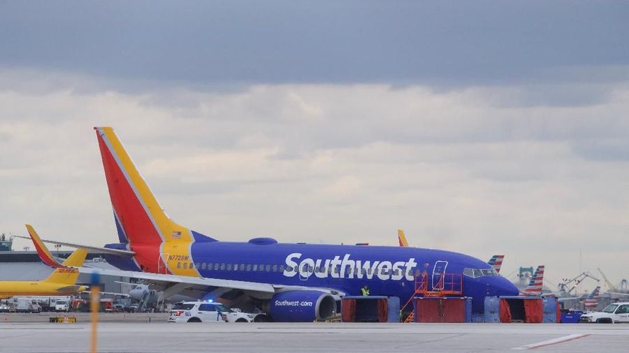 Emergency personnel monitor the damaged engine of Southwest Airlines Flight 1380, which diverted to the Philadelphia International Airport this morning after the airline crew reported damage to one of the aircraft's engines, on a runway in Philadelphia, Pennsylvania U.S. April 17, 2018. REUTERS/Mark Makela
