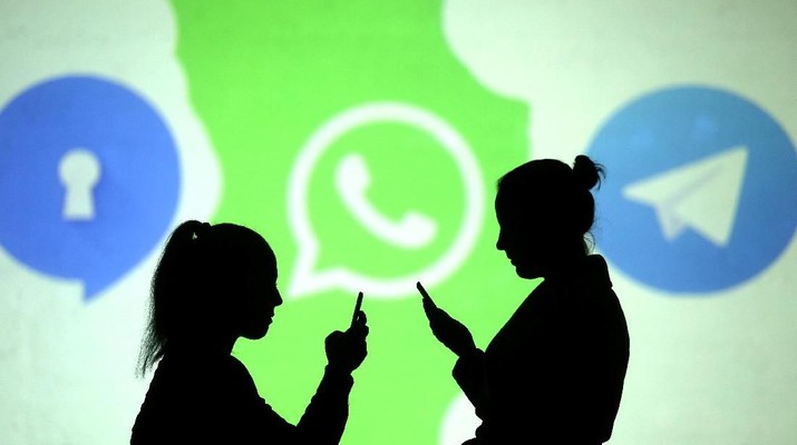REFILE - CLARIFYING CAPTION Silhouettes of mobile users are seen next to logos of social media apps Signal, Whatsapp and Telegram projected on a screen in this picture illustration taken March 28, 2018.  REUTERS/Dado Ruvic