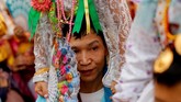 Seorang pria membawa seorang bocah di di pundaknya dalam acara tahunan Poy Sang Long di Mae( Hong Son, Thailand. Festival itu adalah acara perayaan akil balig remaja pria yang akan menjadi pengikut Budha. (Reuters/Jorge Silva)