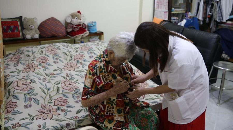 Kanyarat Khonkrit (R) helps her mother Phoem Khonkrit, 91, get dressed for school at their house in Ayutthaya, Thailand, March 14, 2018. They both study at the School for the Elderly in Chiang Rak Noi subdistrict. 