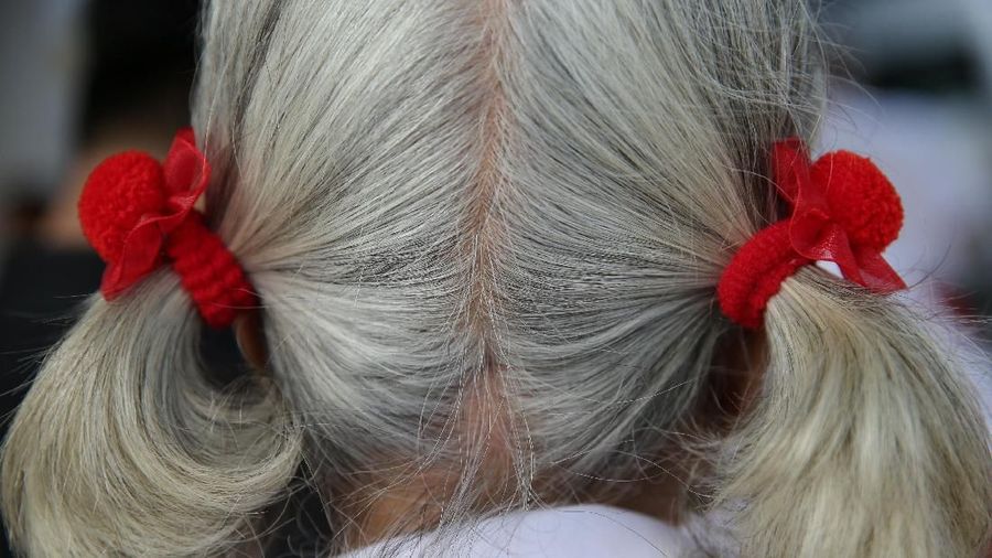 Poonsri Seangnual, 63, has her hair tied back before attending a class at the School for the Elderly in Chiang Rak Noi subdistrict in Ayutthaya, Thailand, March 7, 2018. "I really like going to school. I gained knowledge and it's really fun. I have a lot of friends, know a lot more people," said Seangnual. "I feel lonely whenever I don't go to school, I want to go back and meet my friends. I miss the classroom." REUTERS/Athit Perawongmetha  SEARCH "PERAWONGMETHA SCHOOL" FOR THIS STORY. SEARCH "WIDER IMAGE" FOR ALL STORIES.