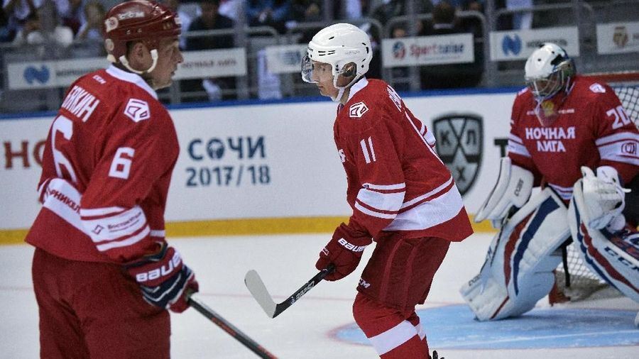 Vladimir Putin  mengenakan seragam berwarna merah dengan nomer 11