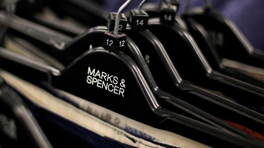 FILE PHOTO: Clothes are displayed on hangers in an M&S shop in northwest London July 8, 2014. REUTERS/Suzanne Plunkett