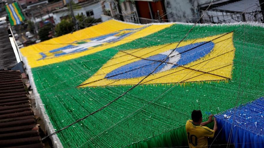 A resident prepares Third Street, in the Alvorada neighborhood, which is decorated for the 2018 World Cup celebrations, in Manaus, Brazil May 13, 2018. Picture taken May 13, 2018. REUTERS/Bruno Kelly