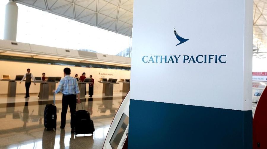 FILE PHOTO: A passenger walks to the First Class counter of Cathay Pacific Airways at Hong Kong Airport in Hong Kong, China April 4, 2018. REUTERS/Bobby Yip