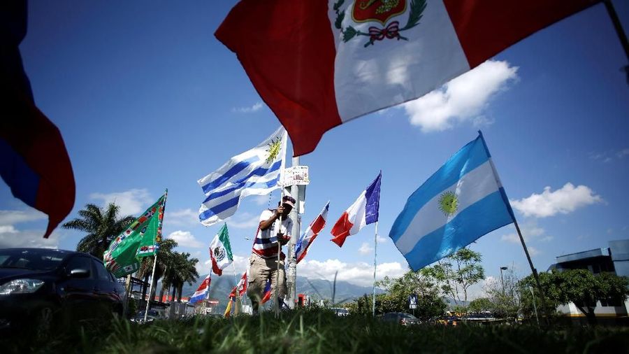 A man sells flags of countries participating in the Soccer World Cup 2018, in San Jose, Costa Rica May 24, 2018. REUTERS/Juan Carlos Ulate