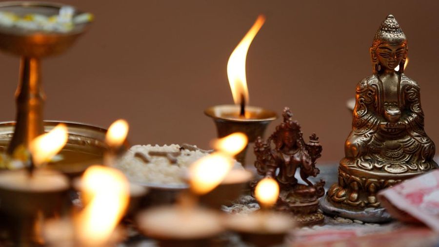 Butter lamps are offered near the idol of Buddha during the birth anniversary of Buddha, also known as Vesak Day, at Boudhanath Stupa in Kathmandu, Nepal April 30, 2018. REUTERS/Navesh Chitrakar