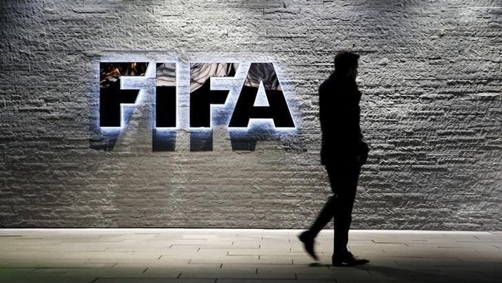 A journalist walks in front of FIFA's headquarters in Zurich, Switzerland December 2, 2015. REUTERS/Arnd Wiegmann