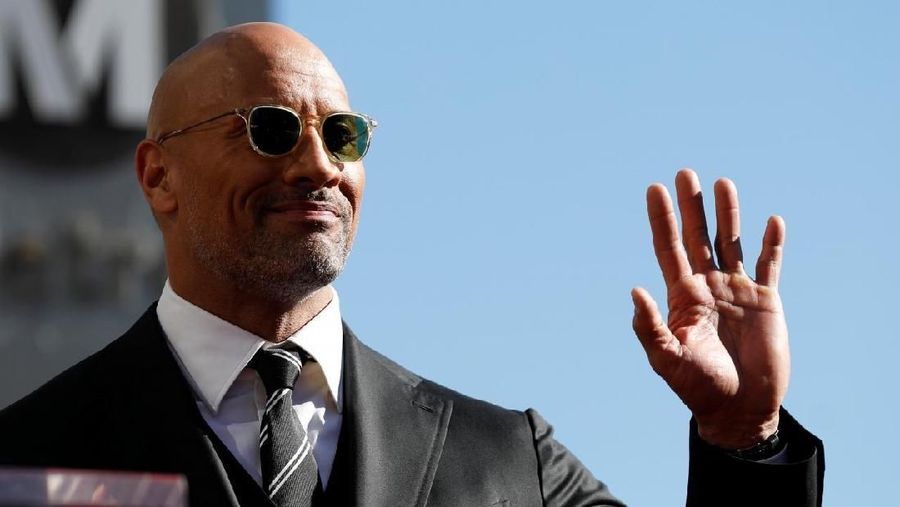 Actor Dwayne Johnson waves before unveiling his star on the Hollywood Walk of Fame in Los Angeles, California, U.S., December 13, 2017. REUTERS/Mario Anzuoni