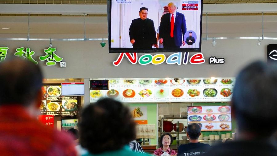 People watch from a shopping mall food court in the Los Angeles neighborhood of Koreatown as Singapore hosts a summit between U.S. President Donald Trump and North Korean leader Kim Jong Un in Los Angeles, California, U.S., June 11, 2018.        REUTERS/Mike Blake