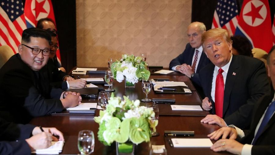 Presiden Amerika Serikat (AS) Donald Trump dan pemimpin Korea Utara, Kim Jong Un, akhirnya saling berjabat tangan dalam tatap muka pertama mereka