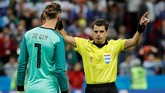 Di hadapan kiper Spanyol David De Gea, wasit Andres Cunha menunjukkan gestur bahwa kontroversi gol Iran akan dilihat di VAR. Usai menunggu beberapa saat, hasilnya gol Iran dianulir. (REUTERS/Toru Hanai)