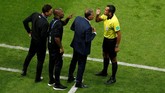 Pelatih Iran Carlos Queiroz (kedua dari kanan) mendapat arahan dari ofisial pertandingan di babak pertama. (REUTERS/John Sibley)