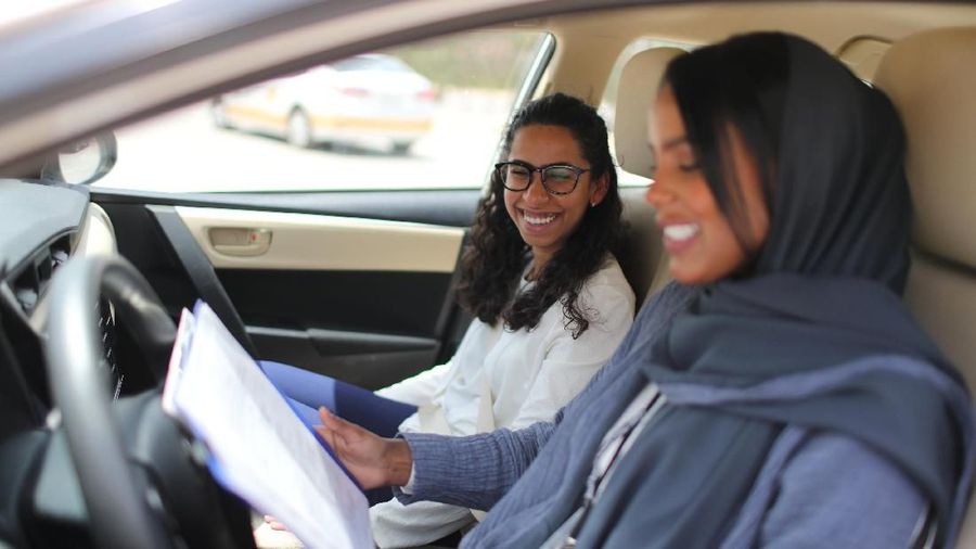 Driving instructor Ahlam al-Somali (R) reads instructions before getting ready to drive with trainee Maria al-Faraj at Saudi Aramco Driving Center in Dhahran, Saudi Arabia, June 6, 2018. REUTERS/Ahmed Jadallah     SEARCH 