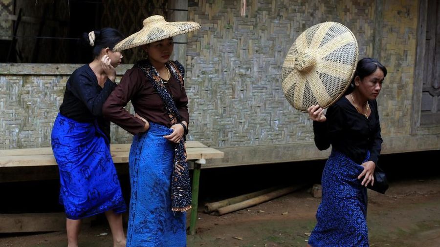 A Baduy woman spreads a batch of clove on top of a bamboo roof to dry at Kanekes village in Rangkasbitung, Banten province, Indonesia, June 27, 2018. REUTERS/Beawiharta