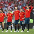 Soccer Football - World Cup - Round of 16 - Spain vs Russia - Luzhniki Stadium, Moscow, Russia - July 1, 2018  Spain's Andres Iniesta, Gerard Pique and team mates look dejected after losing the penalty shootout   REUTERS/Carl Recine