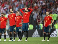 Soccer Football - World Cup - Round of 16 - Spain vs Russia - Luzhniki Stadium, Moscow, Russia - July 1, 2018  Spain's Andres Iniesta, Gerard Pique and team mates look dejected after losing the penalty shootout   REUTERS/Carl Recine
