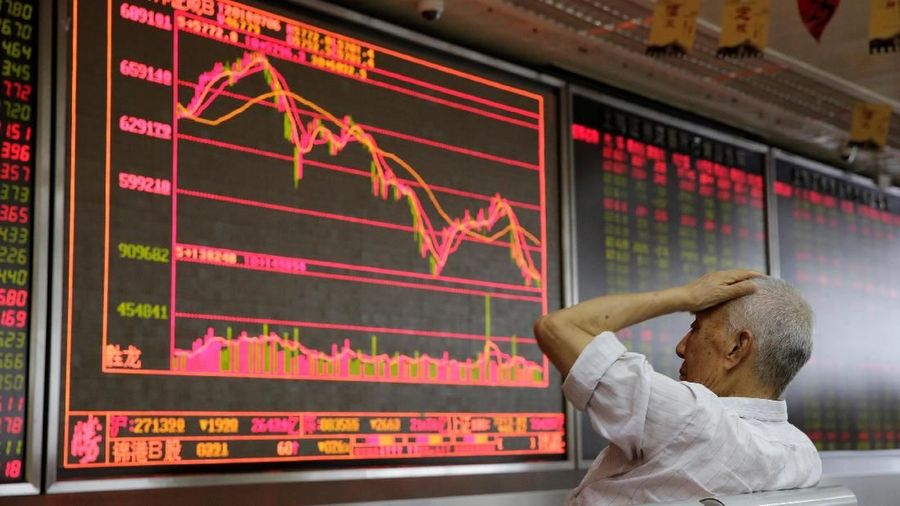 An investor looks at a board showing stock information at a brokerage office in Beijing, China July 6, 2018. REUTERS/Jason Lee