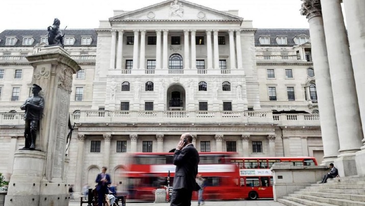 FILE PHOTO - A man talks on a mobile phone as people walk past the Bank of England, in London, Britain September 21, 2017. REUTERS/Mary Turner