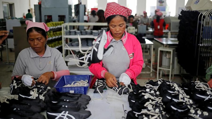 Women work on the production line at Complete Honour Footwear Industrial, a footwear factory owned by a Taiwan company, in Kampong Speu, Cambodia, July 5, 2018. REUTERS/Ann Wang    SEARCH 