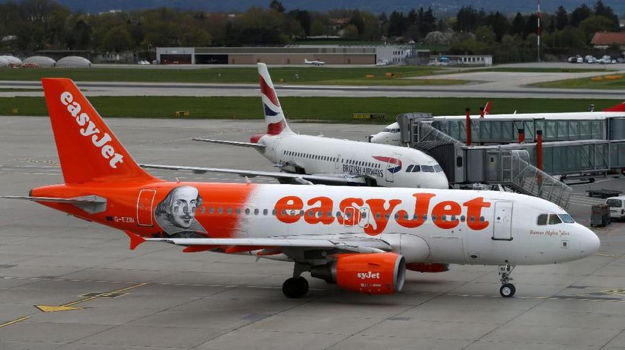 FILE PHOTO: A British Airways and an Easyjet aircraft are pictured at Cointrin airport in Geneva, Switzerland, April 13, 2016. Picture taken through a window. REUTERS/Denis Balibouse/File Photo