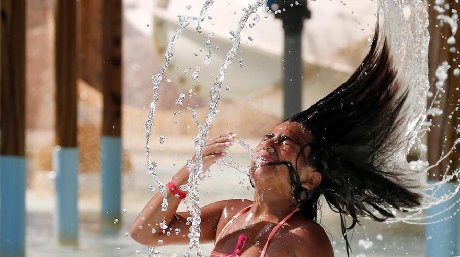 An Egyptian girl plays with water to cool off in hot and humid weather inside an Aqua arena during summer holidays at El Ain El Sokhna in Suez, east of Cairo, Egypt July 21, 2018. REUTERS/Amr Abdallah Dalsh