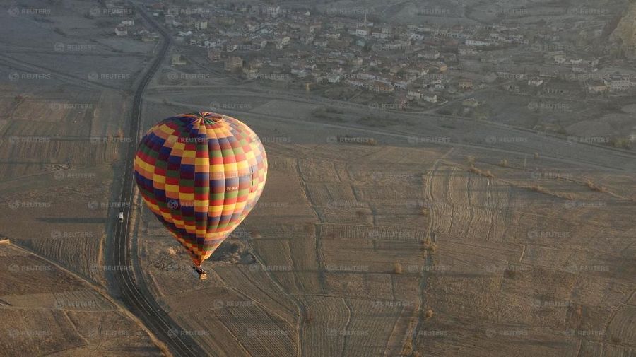 A hot air balloon is seen over Cappadocia December 12, 2008. Cappadocia is a popular tourist destination in Turkey renowned for unusual rock formations and rock-caved churches. Picture taken December 12, 2008. REUTERS/Tan Shung Sin (TURKEY)